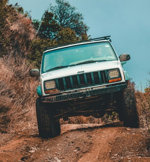 White Jeep Suv Cruising Down the Road